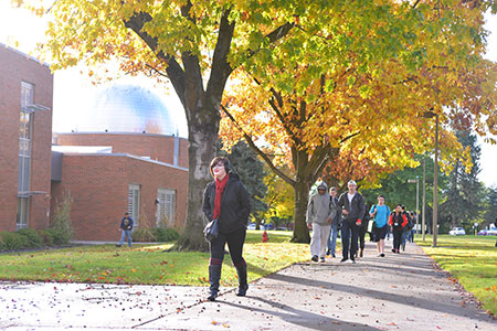 Students walking under fall colors on SFCC campus.